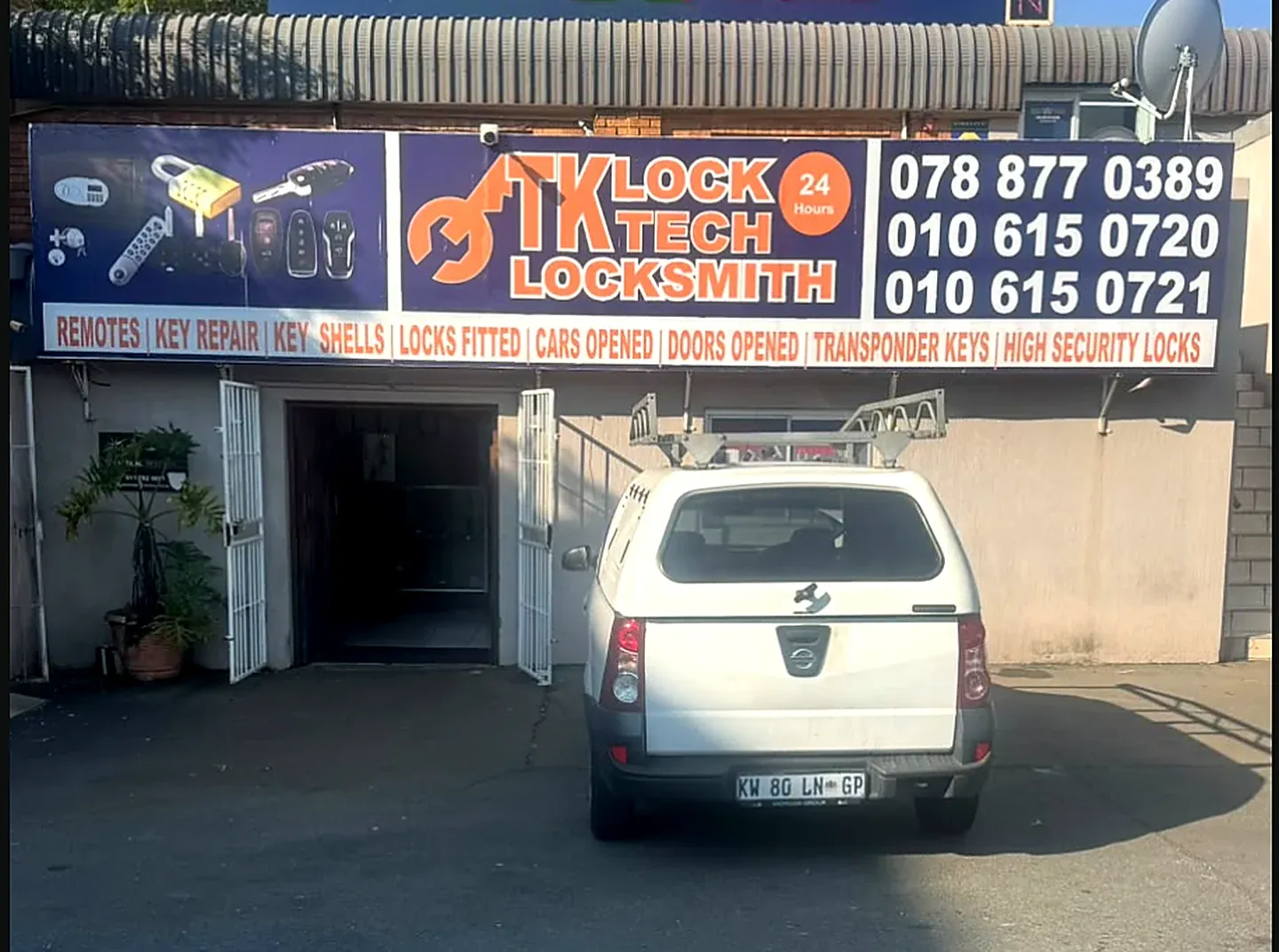 The TK Lock & Key locksmith shopfront in Rivonia, signage showing remotes, key repair, locks fitted, cars opened and transponder keys, with the service vehicle parked outside
